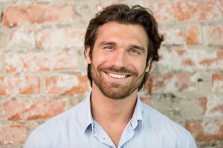 Smiling man with beard and long hair